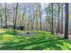 Large green backyard featuring a firepit at 477 Victoria Rd, Woodstock, GA 30189