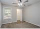 Cozy bedroom featuring neutral walls, carpet, ceiling fan, and a closet for optimal storage at 477 Victoria Rd, Woodstock, GA 30189