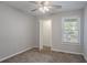 Comfortable bedroom with neutral walls, carpet, ceiling fan, and a closet for storage at 477 Victoria Rd, Woodstock, GA 30189