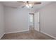 Neutral bedroom showcases a ceiling fan, carpet and an ensuite bathroom at 477 Victoria Rd, Woodstock, GA 30189