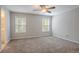 The spacious bedroom boasts dual windows, soft carpet, and an ensuite bathroom at 477 Victoria Rd, Woodstock, GA 30189