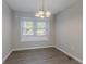 Cozy dining room illuminated by a chandelier, showcasing natural light at 477 Victoria Rd, Woodstock, GA 30189