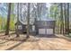 Charming home nestled among trees with a two-car garage and cozy front porch at 477 Victoria Rd, Woodstock, GA 30189