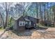 Exterior view of the home showcasing the deck and wooded lot at 477 Victoria Rd, Woodstock, GA 30189