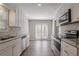 Bright kitchen featuring stainless steel appliances and double doors to the backyard at 477 Victoria Rd, Woodstock, GA 30189