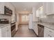 Well-lit kitchen with stainless steel appliances and an open layout to dining area at 477 Victoria Rd, Woodstock, GA 30189