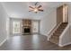 Spacious living room featuring a stone fireplace and staircase at 477 Victoria Rd, Woodstock, GA 30189