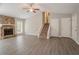 Open living room with cozy stone fireplace and hardwood floors at 477 Victoria Rd, Woodstock, GA 30189