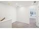 Upstairs hallway is bright and open with views of the nearby townhomes at 314 White Tail Rd, Stockbridge, GA 30253