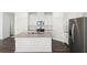 Modern kitchen with white cabinets, granite countertops, stainless steel appliances and island at 360 White Tail Rd, Stockbridge, GA 30253