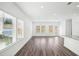 Bright living room with hardwood floors and multiple windows providing natural light at 360 White Tail Rd, Stockbridge, GA 30253