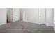 Large bedroom with neutral carpet featuring hallway and closet entrance, offering a spacious and functional layout at 353 White Tail Rd, Stockbridge, GA 30253