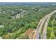 An aerial view showing highway and bridge access near a neighborhood surrounded by nature at 1780 Riverglen Dr, Suwanee, GA 30024