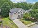 Beautiful aerial view of a home with a well-maintained lawn and mature trees, showcasing its desirable location at 1780 Riverglen Dr, Suwanee, GA 30024