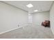 Finished basement with neutral walls and carpet, recessed lights, and chair at 1780 Riverglen Dr, Suwanee, GA 30024