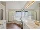 Primary bathroom with double sinks, glass shower and a soaking tub at 1780 Riverglen Dr, Suwanee, GA 30024