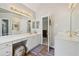 Bright bathroom with double sinks, granite counters, and modern lighting at 1780 Riverglen Dr, Suwanee, GA 30024