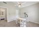 Bedroom with neutral color palette, desk, shelving and adjacent bathroom at 1780 Riverglen Dr, Suwanee, GA 30024