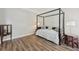 Bedroom featuring wood floors and antique style accents at 1780 Riverglen Dr, Suwanee, GA 30024