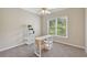 Well-lit bedroom with neutral color palette, desk, shelving, and a large window at 1780 Riverglen Dr, Suwanee, GA 30024