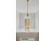 A chandelier with a gold chain and glass casing providing interior lighting at 1780 Riverglen Dr, Suwanee, GA 30024