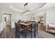 Dining room with hardwood floors and dining table for eight; open to living spaces at 1780 Riverglen Dr, Suwanee, GA 30024