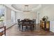 Elegant dining room showcasing tray ceilings, wood floors, and a decorative chandelier at 1780 Riverglen Dr, Suwanee, GA 30024