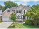 Beautiful two-story home with a well-maintained lawn and landscaping, showcasing its inviting curb appeal at 1780 Riverglen Dr, Suwanee, GA 30024