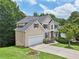 Lovely home with a two-car garage, manicured lawn, and mature trees, offering a blend of comfort and style at 1780 Riverglen Dr, Suwanee, GA 30024