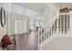 Bright two-story foyer features hardwood flooring, white staircase and views of the dining room at 1780 Riverglen Dr, Suwanee, GA 30024