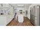 Bright kitchen showcasing white cabinets, stainless steel appliances, a kitchen island, and wood floors at 1780 Riverglen Dr, Suwanee, GA 30024