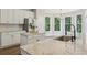 Updated kitchen featuring granite countertops, stainless steel appliances, and a breakfast nook with ample natural light at 1780 Riverglen Dr, Suwanee, GA 30024