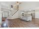 Open floor plan featuring living room and kitchen with fireplace, hardwood floors and large staircase at 1780 Riverglen Dr, Suwanee, GA 30024