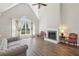 Bright living room boasts vaulted ceiling, fireplace with decorative mantle, and large arched windows for ample natural light at 1780 Riverglen Dr, Suwanee, GA 30024