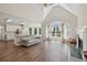 Open concept living room with vaulted ceilings, fire place, hardwood floors, and lots of natural light at 1780 Riverglen Dr, Suwanee, GA 30024