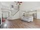 Open floor plan featuring living room and kitchen with fireplace, hardwood floors and large staircase at 1780 Riverglen Dr, Suwanee, GA 30024