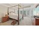 Main bedroom with canopy bed, tray ceiling, and a wall of windows at 1780 Riverglen Dr, Suwanee, GA 30024