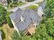 Aerial view of home featuring a spacious deck, bay window, and lush green surroundings at 1780 Riverglen Dr, Suwanee, GA 30024