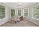 Sitting room surrounded by windows with plush chair at 1780 Riverglen Dr, Suwanee, GA 30024