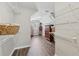 Walk-in closet featuring custom shelving and hardwood floors at 1780 Riverglen Dr, Suwanee, GA 30024