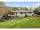 Large backyard featuring lush lawn, patio, and deck at 2506 Parkdale Ne Pl, Atlanta, GA 30305