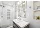 Bright bathroom with a glass-enclosed shower, modern vanity, and decorative shelves at 2506 Parkdale Ne Pl, Atlanta, GA 30305