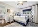Bedroom featuring a bed with blue accents, a window with curtains, and a bedside table at 2506 Parkdale Ne Pl, Atlanta, GA 30305