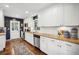 Well-lit kitchen boasts white cabinets, modern appliances, granite countertops and hardwood floors at 2506 Parkdale Ne Pl, Atlanta, GA 30305