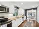 Bright kitchen boasts white subway tile, modern stainless appliances, and granite countertops at 2506 Parkdale Ne Pl, Atlanta, GA 30305