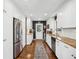 Long galley kitchen featuring white cabinets, stainless steel appliances, and hardwood flooring at 2506 Parkdale Ne Pl, Atlanta, GA 30305