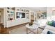 Bright living room features hardwood floors, white built-in shelving and cabinets and modern decor at 2506 Parkdale Ne Pl, Atlanta, GA 30305