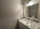 Bathroom featuring vanity with granite countertop and a decorative mirror at 5806 Par Four Ct, Lithonia, GA 30038