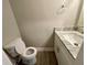 Modern bathroom featuring a toilet and vanity with a light countertop at 5806 Par Four Ct, Lithonia, GA 30038