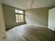 Spacious bedroom with tall window for light and wood grain floors at 5806 Par Four Ct, Lithonia, GA 30038